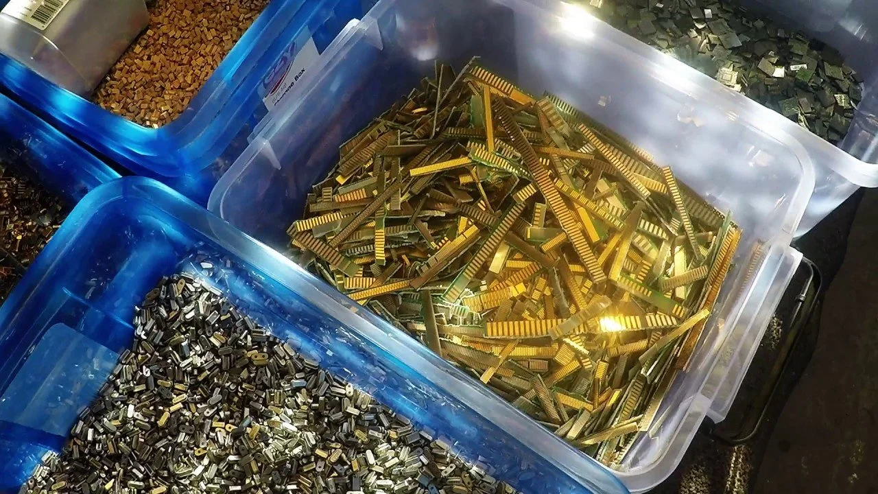 Gold pins recovered from electronics in a tray